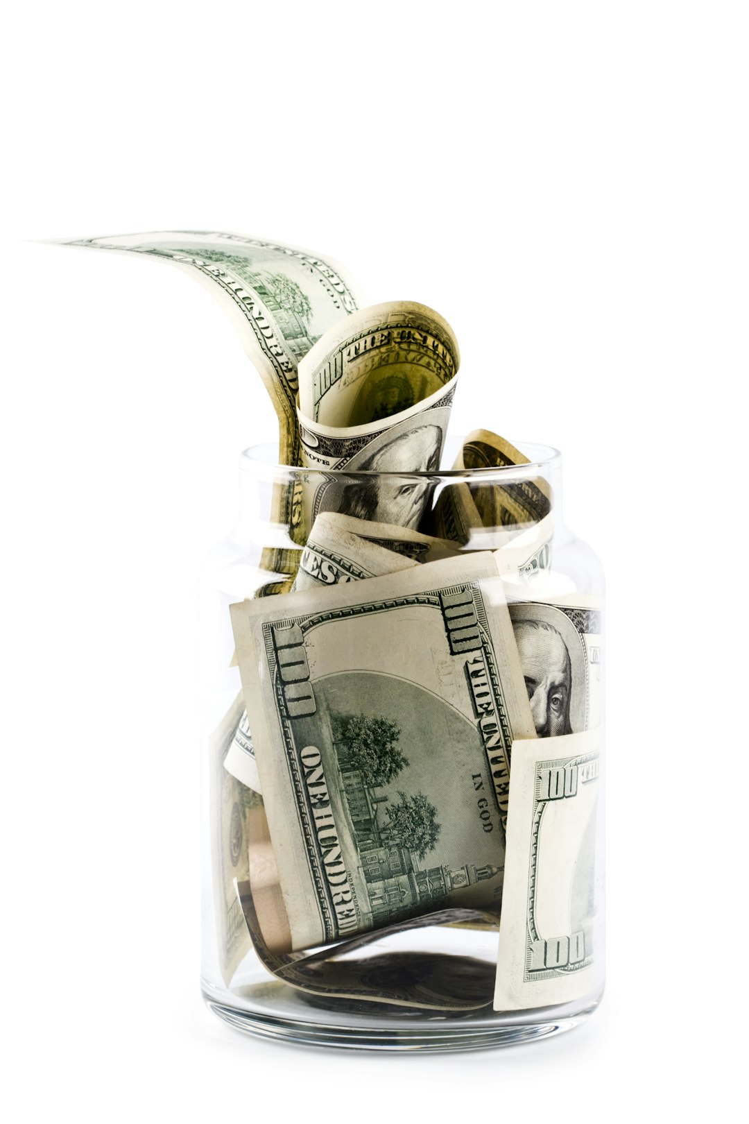 a-glass-jar-filled-with-money-on-top-of-a-table-pawn1jiwvyg